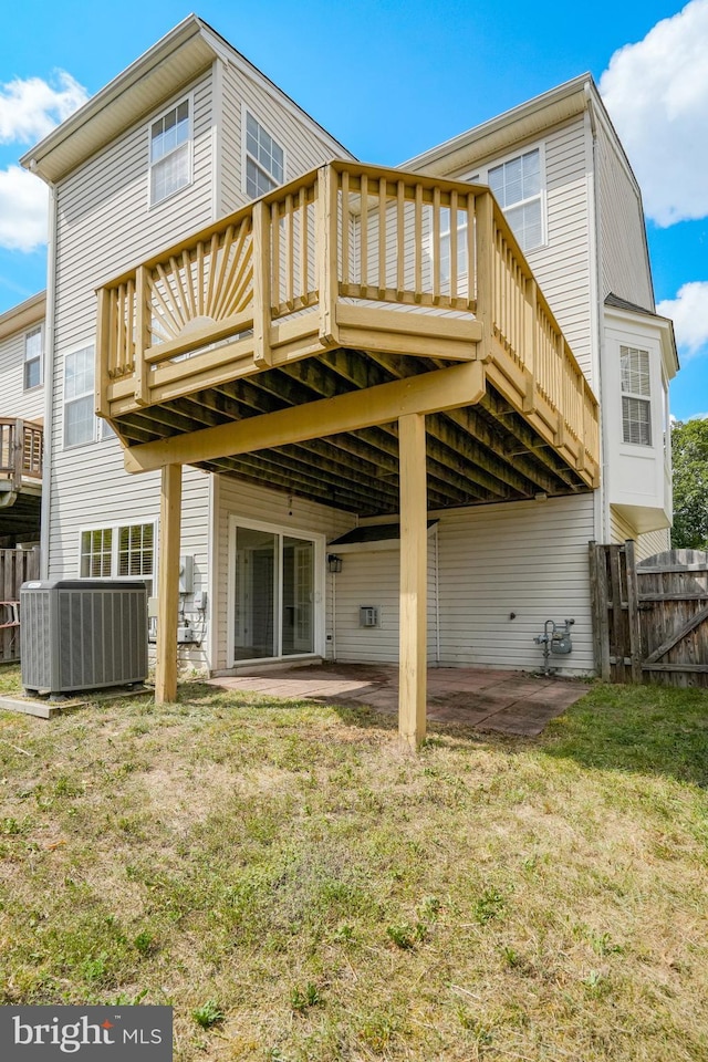 back of property with a patio, central air condition unit, and fence