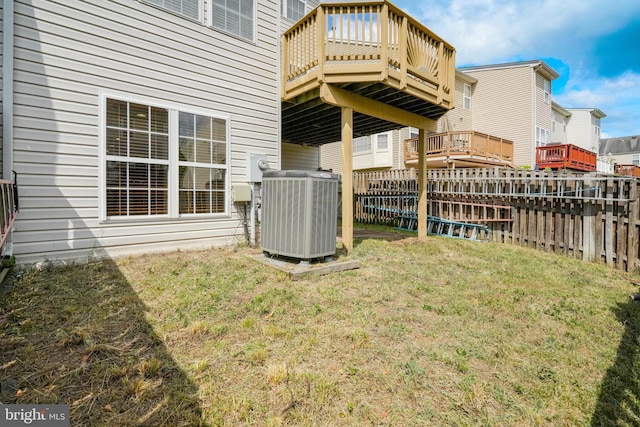 view of yard with central air condition unit and fence