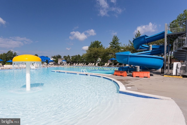 pool featuring a patio area and a water slide