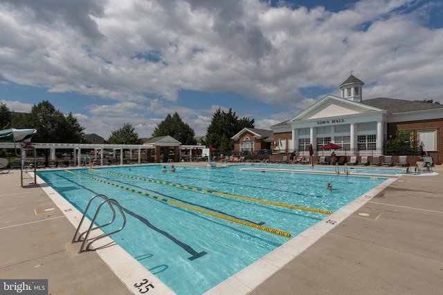 community pool featuring a patio and fence