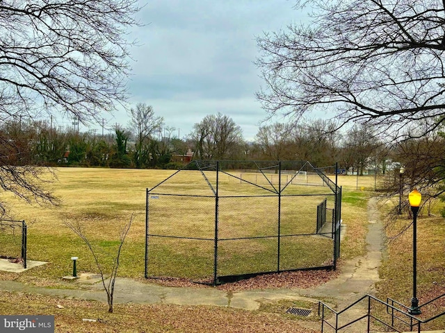 view of community featuring a yard and fence