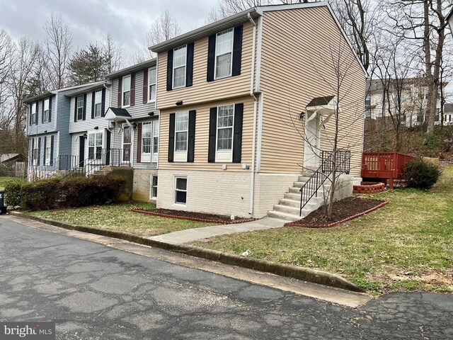 view of side of property with a lawn