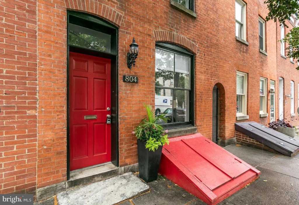 entrance to property with brick siding