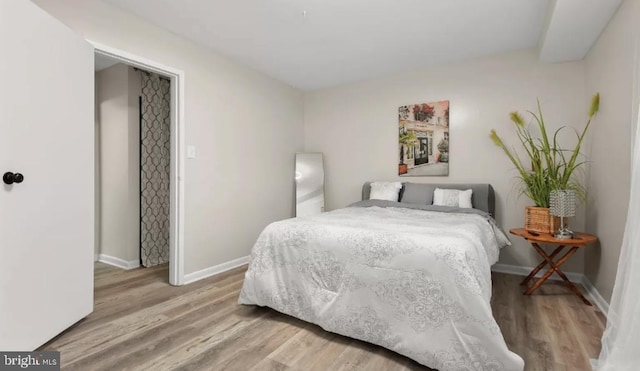 bedroom with baseboards and light wood-style floors