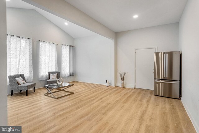 living area featuring vaulted ceiling, recessed lighting, and wood finished floors