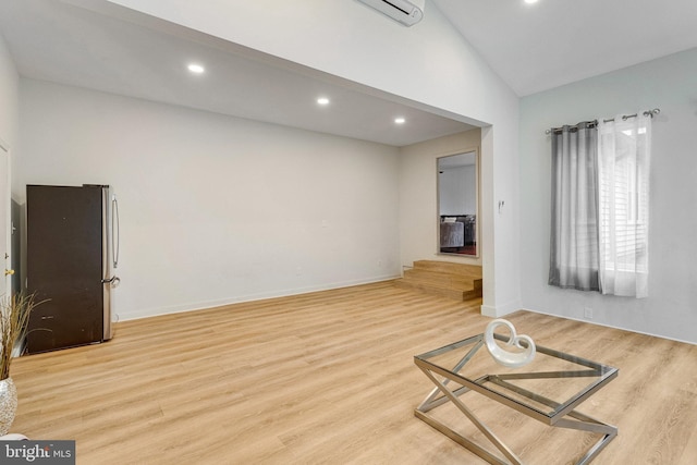 living area featuring recessed lighting, baseboards, lofted ceiling, and light wood-style floors