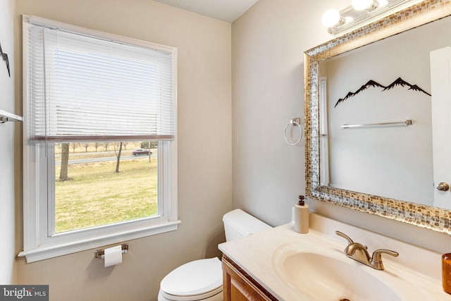 bathroom with toilet and vanity