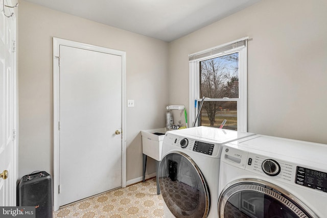 clothes washing area with laundry area, independent washer and dryer, and light floors