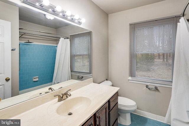 bathroom featuring tile patterned floors, toilet, baseboards, and plenty of natural light