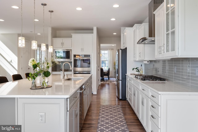 kitchen with tasteful backsplash, stainless steel appliances, light countertops, a sink, and dark wood-style floors