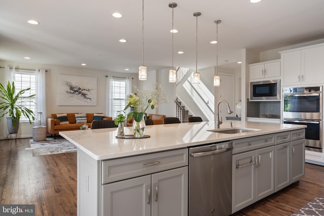 kitchen featuring appliances with stainless steel finishes, a wealth of natural light, recessed lighting, and a sink