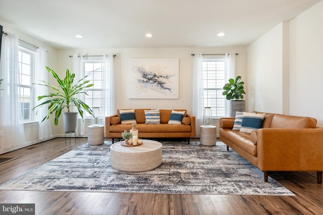 living room with wood finished floors, recessed lighting, and baseboards