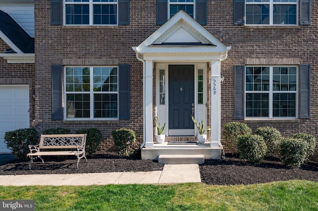 property entrance featuring brick siding