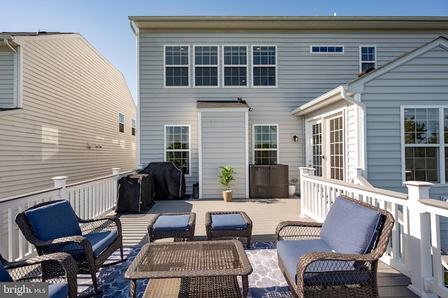 exterior space featuring an outdoor living space, french doors, and grilling area