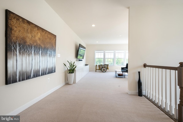 hall featuring recessed lighting, an upstairs landing, carpet, and baseboards
