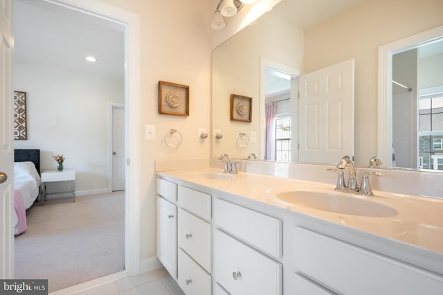 ensuite bathroom with baseboards, ensuite bathroom, double vanity, and a sink