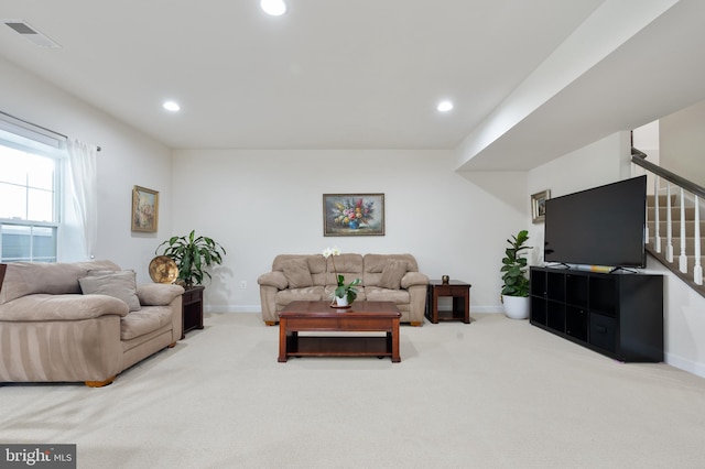 carpeted living area with recessed lighting, visible vents, stairway, and baseboards