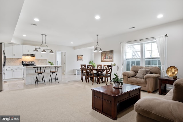 living area with visible vents and recessed lighting