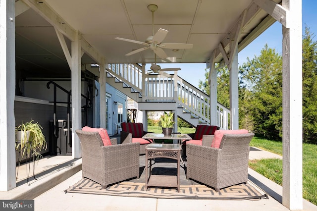view of patio featuring an outdoor living space, ceiling fan, and stairway