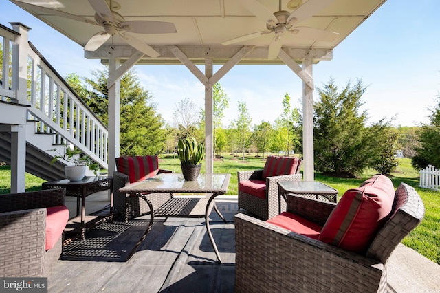 view of patio with outdoor lounge area, a ceiling fan, and stairway