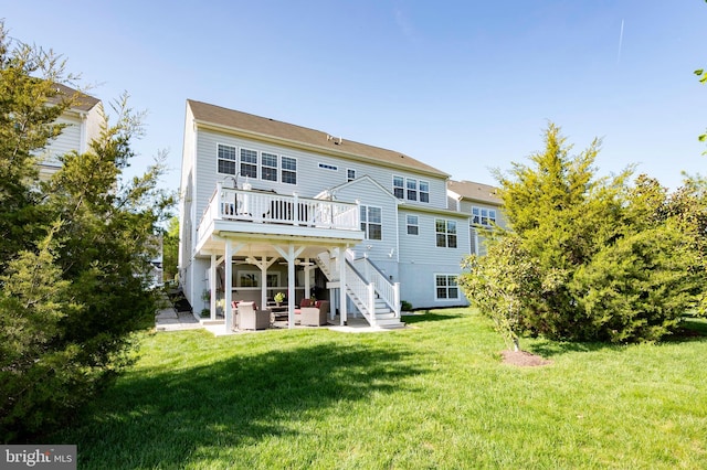 rear view of property featuring a patio, a deck, stairway, a yard, and an outdoor living space