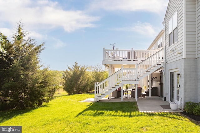 view of yard with a patio, a deck, and stairs