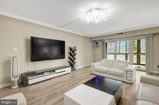 living room featuring crown molding, wood finished floors, visible vents, and baseboards