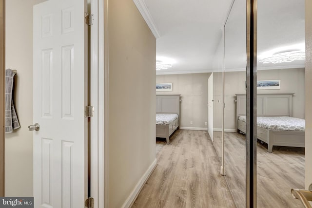 unfurnished bedroom with baseboards, light wood-type flooring, and ornamental molding