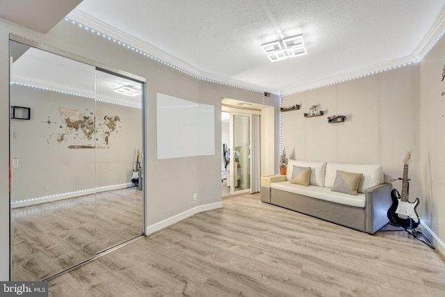 sitting room featuring crown molding, wood finished floors, and baseboards