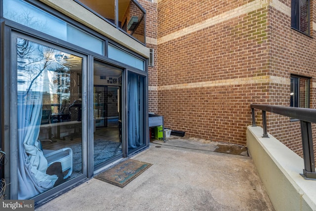 view of exterior entry with brick siding