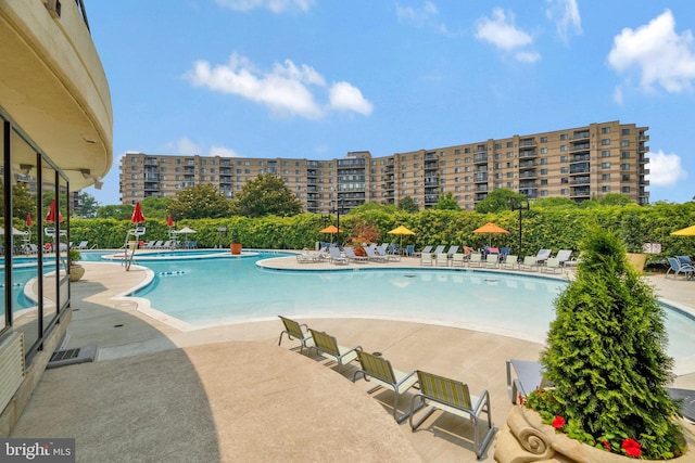 community pool featuring a view of city and a patio