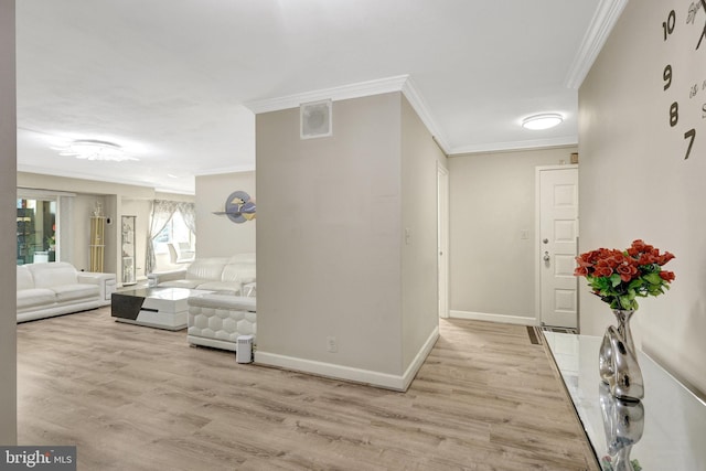 hall with baseboards, light wood-style floors, and crown molding