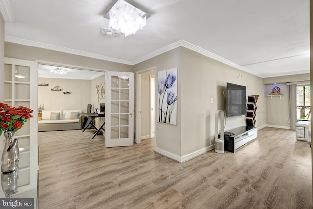 entrance foyer featuring crown molding, wood finished floors, and baseboards