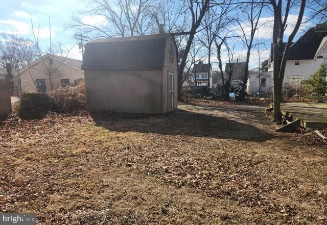 exterior space with a storage shed and an outbuilding