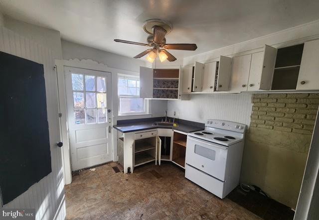 kitchen with a sink, open shelves, ceiling fan, and white range with electric cooktop