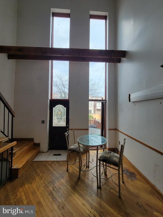 dining area with baseboards, stairs, and hardwood / wood-style flooring