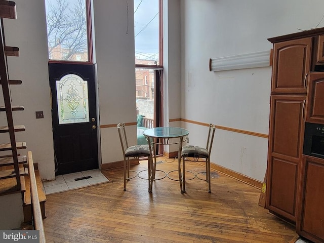 entrance foyer with light wood-style floors and baseboards