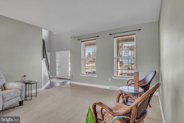 sitting room featuring visible vents, baseboards, and carpet floors