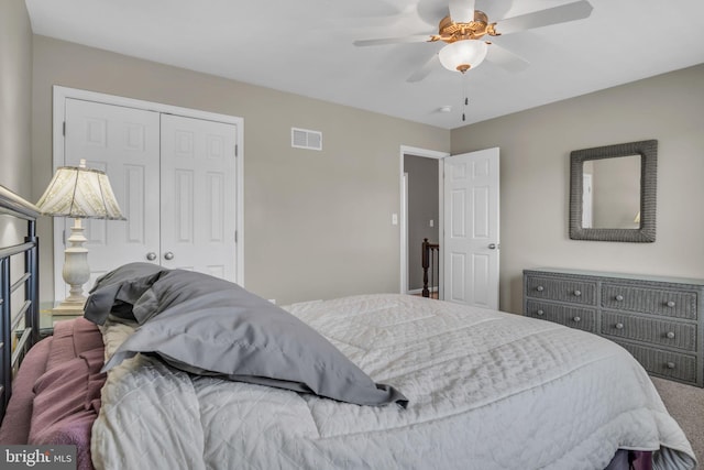 bedroom featuring a closet, visible vents, ceiling fan, and carpet floors