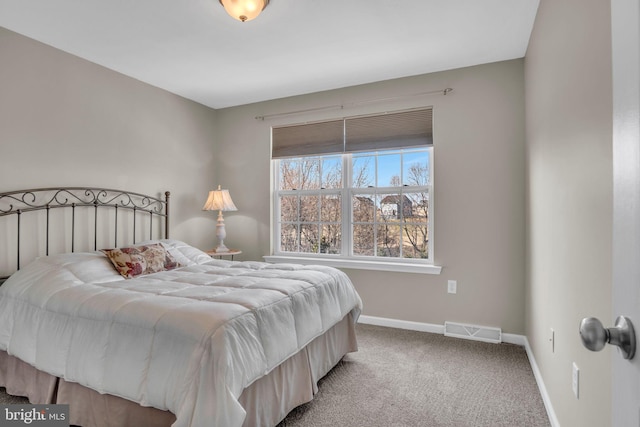 carpeted bedroom with visible vents and baseboards