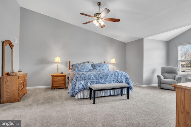 carpeted bedroom with lofted ceiling, a ceiling fan, and baseboards