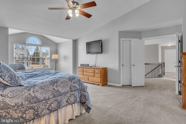 bedroom featuring lofted ceiling, light colored carpet, baseboards, and ceiling fan