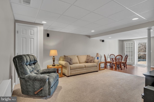 living room with recessed lighting, visible vents, a paneled ceiling, and carpet