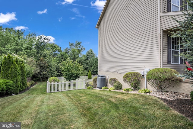 view of yard featuring cooling unit and fence