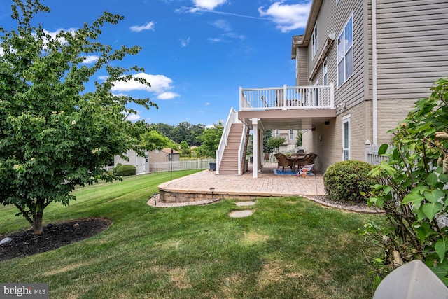 view of yard featuring a wooden deck, stairs, and a patio area