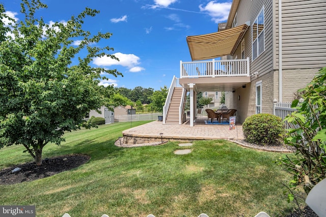 view of yard featuring stairs, a patio, a deck, and fence