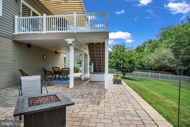 view of patio featuring a fire pit, outdoor dining space, stairs, and fence