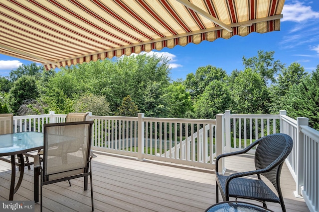 wooden terrace with outdoor dining space