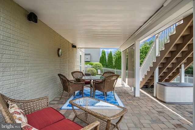 view of patio / terrace with stairs, outdoor dining area, and fence