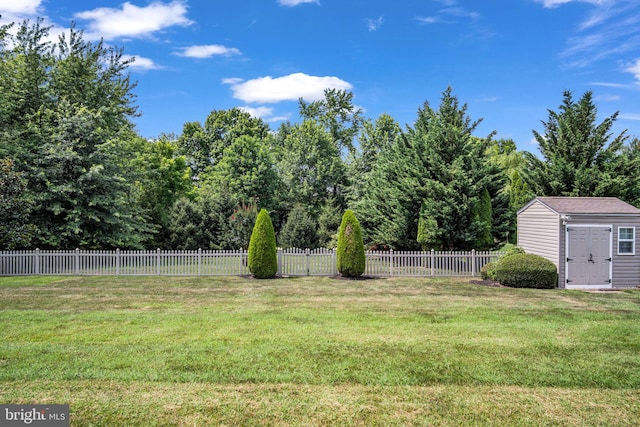 view of yard featuring an outbuilding, fence private yard, and a shed